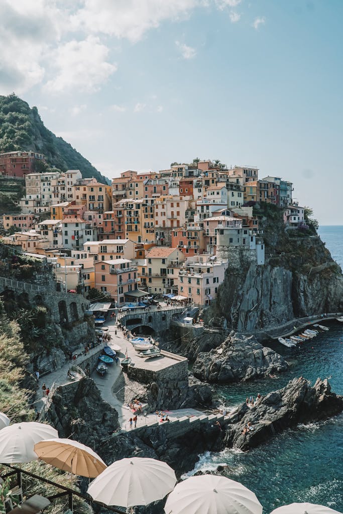 Discover the vibrant coastal houses of Manarola, nestled on Italy's scenic cliffs with breathtaking sea views.